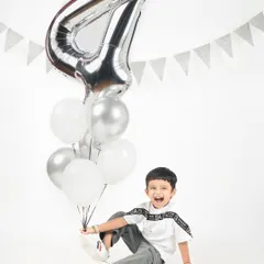 Look at that big, joyful smile. This little boy is so excited to be celebrating his fourth birthday in the studio.