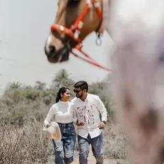 A candid moment captured during a country-style photoshoot, with the horse adding a unique element to the frame.