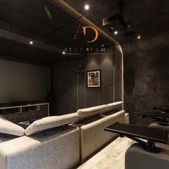 The room includes multiple tiers of seating with both a large sofa and dedicated recliners with tray tables, ensuring comfort for all guests.