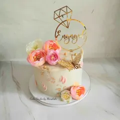 Perfect for an intimate Roka or engagement party, this single-tier cake is all about simple elegance. It's a no-fondant design decorated with fresh flowers, a golden butterfly, and a custom 'Engaged' topper.