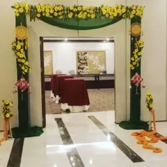 A beautifully decorated entrance for a Haldi or Mehendi event. We use fabric draping, floral arrangements, and traditional hangings to create a welcoming entryway for your guests.