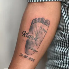 I specialize in immortalizing your most precious memories. This tattoo captures the exact footprint of a client's newborn, complete with their name, birth date, and weight, creating a timeless tribute to a new life.