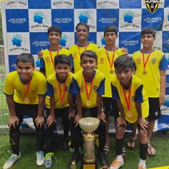 A proud moment for our youth team, posing with their medals and the championship trophy. We focus on building a winning mentality from the ground up.