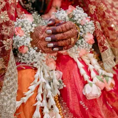 The beauty is in the details. This close-up from a Muslim wedding highlights the intricate henna, floral garlands, and traditional attire that make each celebration unique.