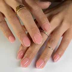 A beautiful, natural-looking manicure with a sheer pink gel overlay on rounded nails. This enhances your natural nails for a polished, 'your nails but better' look.