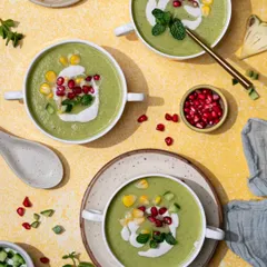 A happy, sunny soup post. This cool cucumber soup is styled on a bright yellow background with fresh garnishes, making it look perfect for a hot afternoon.