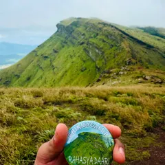 Our "Chikmagalur" badge held against one of the region's iconic peaks. A great souvenir from an amazing trip.