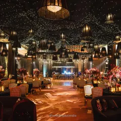 We believe in making weddings cinematic. For this Udaipur sangeet, we designed a starry night ceiling with hundreds of fairy lights and dramatic black lampshades, creating a moody, romantic, and utterly unforgettable ambiance for a night of celebration.