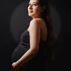A simple, elegant solo portrait in a black strapless gown. The studio spotlighting is designed to beautifully sculpt the light and create a timeless, classic look.
