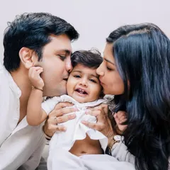 Kisses from both mom and dad for their happy little one. My goal is to create images that you will look back on with warmth and nostalgia, remembering the love that filled your home.