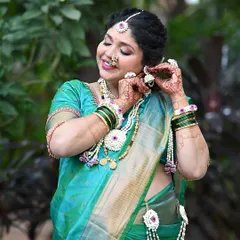 A sweet moment of the mom-to-be adjusting her floral earring. The makeup is kept fresh and radiant to celebrate this special milestone.