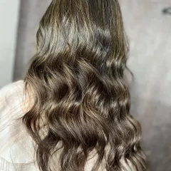 The beautiful result of the ash blonde highlights, styled in loose waves.