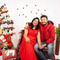 A happy couple enjoying a festive Christmas-themed photoshoot in the studio. These sessions are perfect for holiday cards and creating seasonal memories.