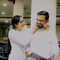 A playful and affectionate moment between the two doctors. Her gentle touch and his happy smile make this a heartwarming and genuine portrait that perfectly captures their dynamic.