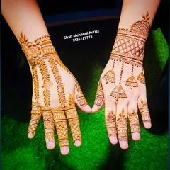 A clear, top-down view of the jhumka and vine designs, showing the clean application.