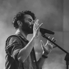 A monochrome shot capturing a quiet, emotional moment during a live performance. Whether it's a high-energy song or a soft ballad, I always sing from the heart.