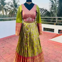 A traditional long gown made from silk saree fabric. This one features a beautiful parrot green and pink combination.