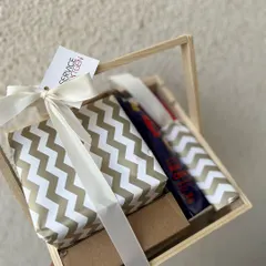 A classy and useful birthday gift in a wooden crate. The items are elegantly wrapped, creating a sense of anticipation and making the employee feel truly special on their day.