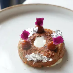 A still life of our Doughnut Kebab. Adorned with edible silver vark and delicate flowers, this dish is a testament to our playful yet elegant approach to progressive Indian cuisine.