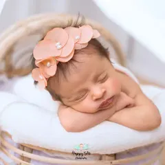 We love using different textures and props. This newborn is nestled in a soft basket with a simple wrap, a classic setup for a timeless newborn photograph.