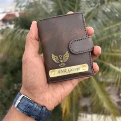 A dark brown faux-leather card holder, personalized for "ANR Groups". This compact wallet features a custom nameplate and a metal eagle charm, making it a great corporate accessory.