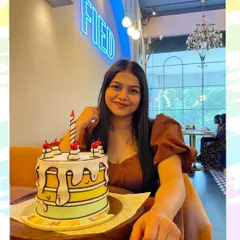 A happy client celebrating her birthday with a unique 2D comic-style cake.