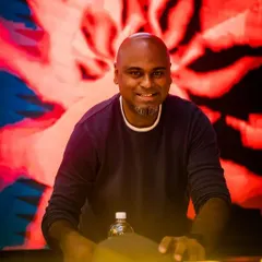 A close-up shot of me at Sugar Factory, with the iconic "SUGAR" logo visible on the DJ booth.