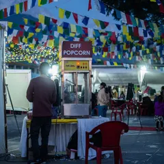 Sometimes the small details tell the biggest story. This candid shot of a popcorn stand under festival flags at DIFF helps build a complete picture of the event experience.