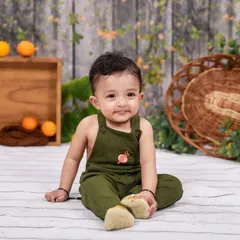 Another angle from a sitter session, capturing a sweet and curious expression. The simple props and background ensure a timeless feel.