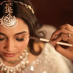 A close-up of the artistry involved. This shot captures the delicate process of applying eyeshadow, a crucial step in creating a flawless and blended look.