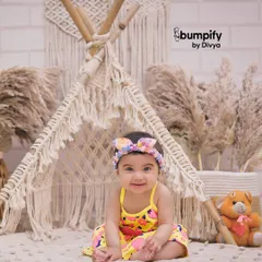 A happy baby in our boho teepee studio setup. This theme is perfect for capturing a child's playful and adventurous spirit in a stylish, modern way.
