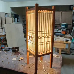 Another angle of a beautiful Kumiko lamp, showcasing the clean lines and the soft diffusion of light through the paper. The dark-stained frame provides a striking contrast to the light-colored wood of the Kumiko pattern.