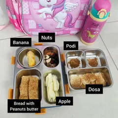 A simple and satisfying lunchbox for school. This one includes mini dosas with podi for dipping, bread with peanut butter, apple slices, a banana, and a mix of nuts for a boost of healthy fats and energy.