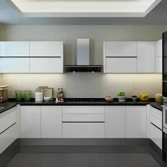 This U-shaped kitchen is the epitome of minimalist design with its all-white, handleless cabinets and a contrasting black countertop. The under-cabinet lighting provides excellent task illumination, while the layout offers an efficient workflow for any home cook.