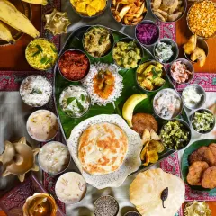 A grand Onam Sadhya, captured from above. This flatlay showcases the incredible variety of dishes in this traditional Keralite feast, with over 20 different items beautifully arranged on a banana leaf. It’s a vibrant tapestry of color, flavor, and culture.