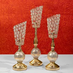 This set of three crystal candle holders adds a touch of glamour to any table setting. The faceted crystals catch the light beautifully, creating a dazzling effect that is perfect for festive occasions.