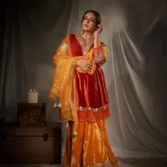 This look captures pure festive opulence. I chose a rich, jewel-toned velvet sharara set in shades of orange and red, accessorized with regal gold jewelry to create a look that is both traditional and incredibly glamorous for any grand celebration.