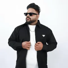 A classic portrait from a studio session. This clean, professional shot is great for press kits and profiles, showing the artist behind the music.