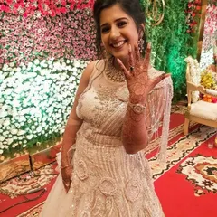 The bride-to-be joyfully displays her engagement mehendi. The intricate floral and vine patterns are perfect for celebrating this special milestone.