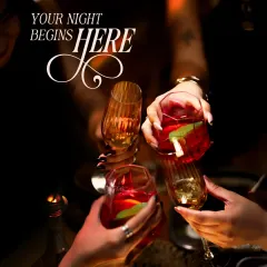 Your night begins here, with the collective clink of glasses. This is the energy I cultivate, a celebratory mood where friends gather to kick off an evening of shared stories and signature cocktails.