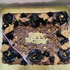 A closer look at my brownie celebration cake, this time on a golden base. It's loaded with chocolate frosting, biscuits, and a birthday topper, ready for a party.