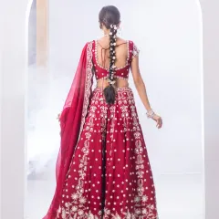 The back of this red bridal lehenga is as stunning as the front. The detailed embroidery and elegant tie-up design ensure you look flawless from every angle on your special day.