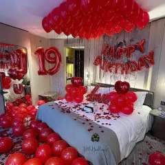 A classic for a reason. This romantic birthday room makeover features a sea of red balloons, rose petals, and bold foil letters to make your loved one feel truly special. It's a full sensory experience of love and celebration.