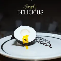 This is my Mango Coconut Shell dessert, a true showstopper. Guests get to crack open a delicate chocolate shell to reveal a luscious mango and coconut mousse center, offering a delightful tropical surprise.