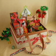 This Christmas-themed hamper is packed in a stylish tote bag. It's filled with Pringles, carrot cake, and other treats, making it a perfect and substantial gift for the holiday season.
