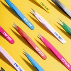 A dynamic, colorful flat lay of Step Zero tweezers. The repetitive pattern and bright yellow background create a visually arresting image for social media and e-commerce banners.