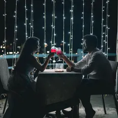 A romantic date night setup is a perfect theme for a pre-wedding shoot. Here, we used fairy lights and a cozy table setting to create an intimate, silhouetted portrait that feels straight out of a movie.