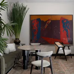 Another view of the India Art Fair VIP Lounge, where a large, colourful painting provides a dramatic backdrop for a dining or meeting area. The space was designed to reflect the depth and evolving language of contemporary Indian design.