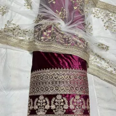I've paired this rich maroon viscose velvet with a delicate embroidered net fabric. This combination is perfect for creating opulent lehengas or salwar suits that feel both royal and handcrafted.