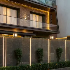 At the Club Drive House, we integrated linear LED strips into the boundary wall. This not only illuminates the perimeter but also creates a strong graphic statement, turning a functional element into a piece of art that complements the home's modern facade.